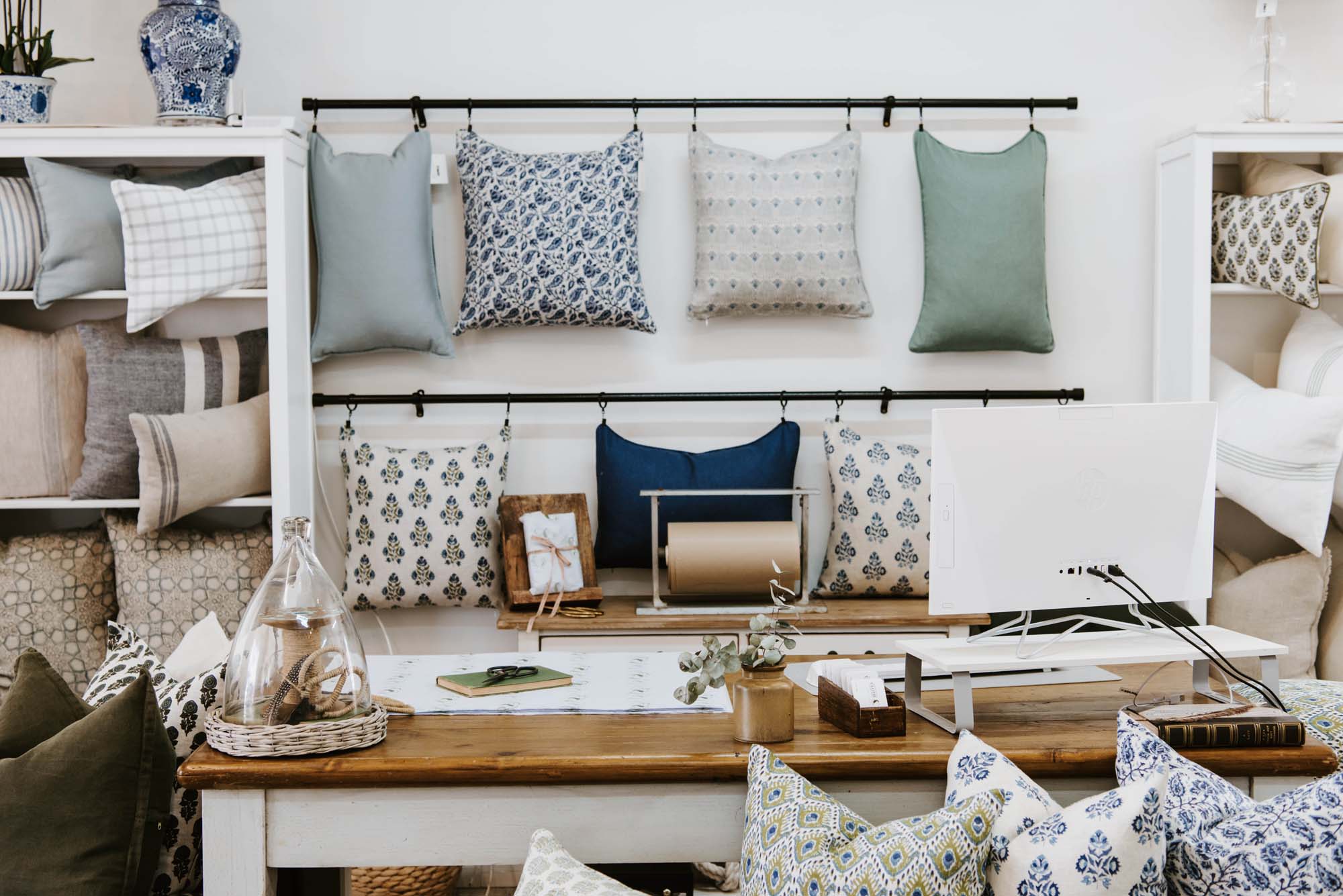 The reception of Cloth & Feather with lots of pillows and a desk.